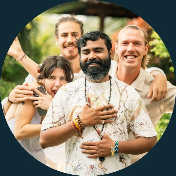 Man with his hands on his heart and people behind him all smiling happily